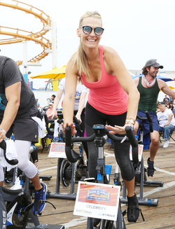 Molly Sims rides a stationary bike for charity