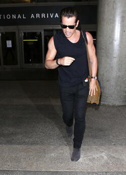 Colin Farrell was spotted in a sleeveless t shirt at LAX