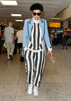 Rita Ora in a Striped Track Suit at Heathrow Airport