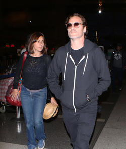 The enigmatic Joaquin Phoenix sports a scruffy beard zip up hoodie and shades as he spends National Brother s Day catching a flight with his lovely sister Summer.
