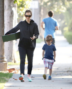 Jennifer Garner carries a school project as she takes her kids to school