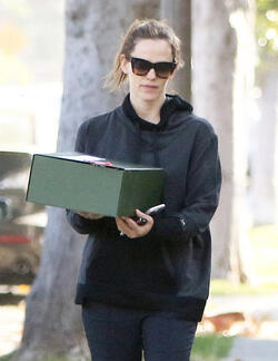 Jennifer Garner carries a school project as she takes her kids to school