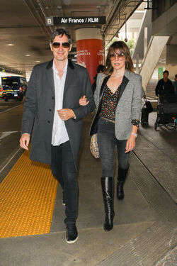 Milla Jovovich and husband director Paul W. S. Anderson were spotted returning to Los Angeles at LAX.