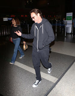 The enigmatic Joaquin Phoenix sports a scruffy beard zip up hoodie and shades as he spends National Brother s Day catching a flight with his lovely sister Summer.