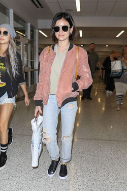 Pretty Little Liars star Lucy Hale looks cute in a rose colored silk bomber light green tee ripped jeans and black tennis shoes as she touches down in L.A. after a long flight from NYC. Pretty Little Liars star Lucy Hale looks cute in a rose colored silk bomber light green tee ripped jeans and black tennis shoes as she touches down in L.A. after a long flight from NYC.