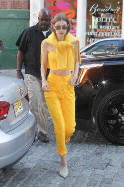 Gigi Hadid wears an all yellow ensemble as she arrives at her apartment