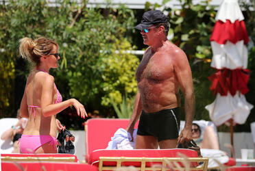 Baywatch actor David Hasselhoff wears tiny black swim trunks as he relaxes with his bikini clad finance Hayley Roberts by the pool in Miami.