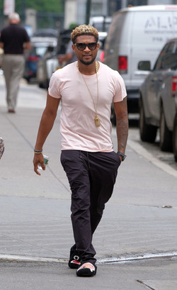 Usher wears comical slippers as he walks in Tribeca
