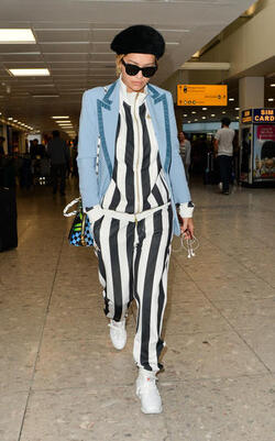 Rita Ora in a Striped Track Suit at Heathrow Airport