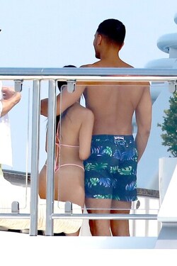 He certainly has some thong to smile about Side boob flashing Kourtney Kardashian s toyboy lover grins as she flaunts her behind in TINY bikini for another day frolicking on a yacht in Cannes