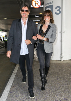 Milla Jovovich and husband director Paul W. S. Anderson were spotted returning to Los Angeles at LAX.