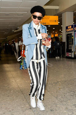 Rita Ora in a Striped Track Suit at Heathrow Airport