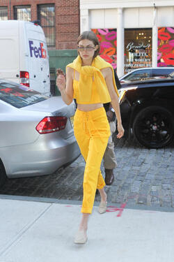 Gigi Hadid wears an all yellow ensemble as she arrives at her apartment
