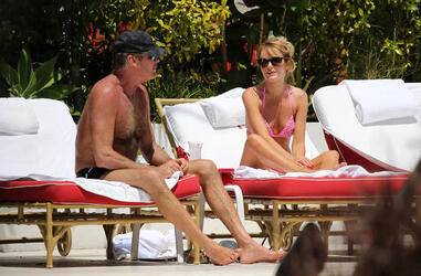 Baywatch actor David Hasselhoff wears tiny black swim trunks as he relaxes with his bikini clad finance Hayley Roberts by the pool in Miami.