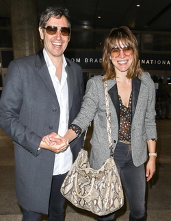 Milla Jovovich and husband director Paul W. S. Anderson were spotted returning to Los Angeles at LAX.
