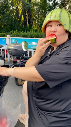 Woman Riding Scooter Uses Half Watermelon For Helmet