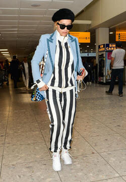 Rita Ora in a Striped Track Suit at Heathrow Airport
