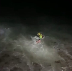 VIDEO Foolish man who went for night time swim in treacherous sea is saved by hero firefighters who dived in after him