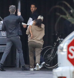 Kim Kardashian carrying a sleepy princess Nori
