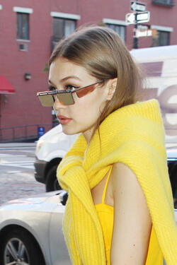 Gigi Hadid wears an all yellow ensemble as she arrives at her apartment