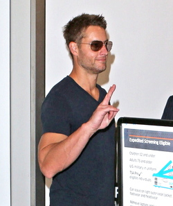 Justin Hartley And Fiance Chrishell Stause Head Out Of LAX On Romantic Holiday