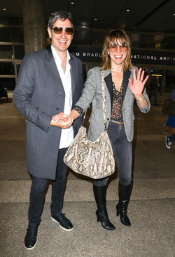 Milla Jovovich and husband director Paul W. S. Anderson were spotted returning to Los Angeles at LAX.