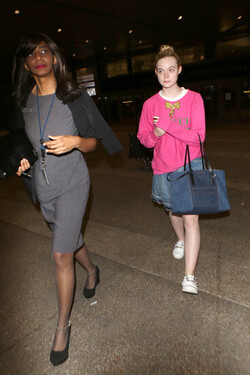 Elle Fanning so pretty in pink Gucci shirt at LAX