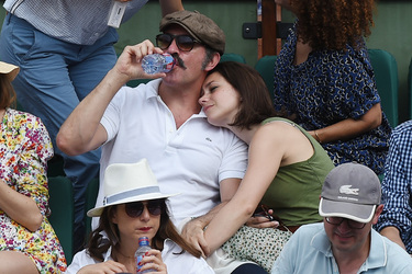 Jean Dujardin and his wife Nathalie Pechalat keep each other moisturised at the French Tennis Open at Roland Garros