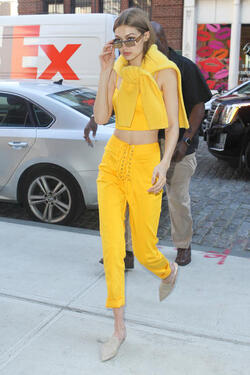 Gigi Hadid wears an all yellow ensemble as she arrives at her apartment