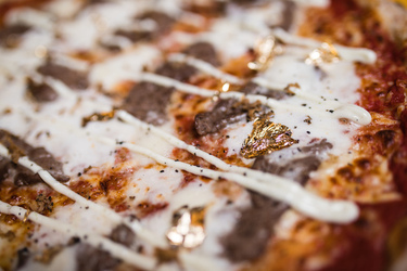 A LOT OF CHEDDAR NEW 2 500 CALORIE PIZZA IS TOPPED WITH 24K GOLD