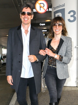 Milla Jovovich and husband director Paul W. S. Anderson were spotted returning to Los Angeles at LAX.
