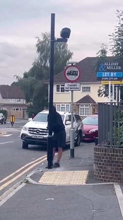 VIDEO Disgruntled masked man hacks down London ULEZ camera in broad daylight 48 hours after it was installed