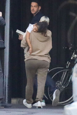 Kim Kardashian carrying a sleepy princess Nori
