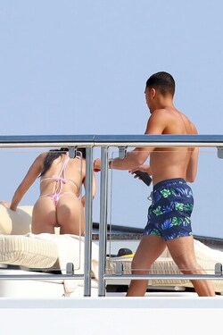 He certainly has some thong to smile about Side boob flashing Kourtney Kardashian s toyboy lover grins as she flaunts her behind in TINY bikini for another day frolicking on a yacht in Cannes
