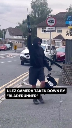 VIDEO Disgruntled masked man hacks down London ULEZ camera in broad daylight 48 hours after it was installed