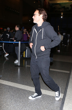 The enigmatic Joaquin Phoenix sports a scruffy beard zip up hoodie and shades as he spends National Brother s Day catching a flight with his lovely sister Summer.