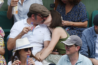Jean Dujardin and his wife Nathalie Pechalat keep each other moisturised at the French Tennis Open at Roland Garros