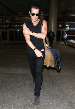 Colin Farrell was spotted in a sleeveless t shirt at LAX