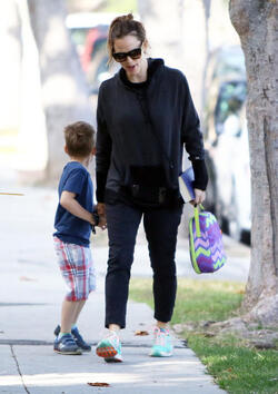 Jennifer Garner carries a school project as she takes her kids to school